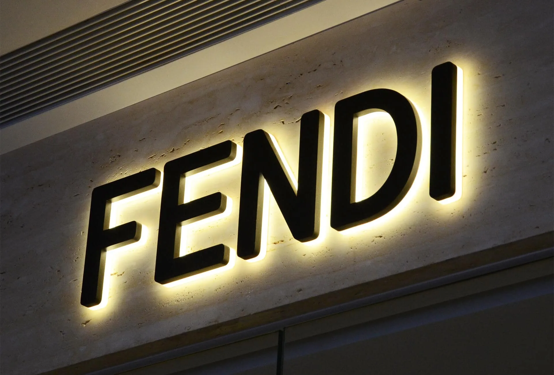 Custom backlit letters installed on a storefront wall with clean LED illumination