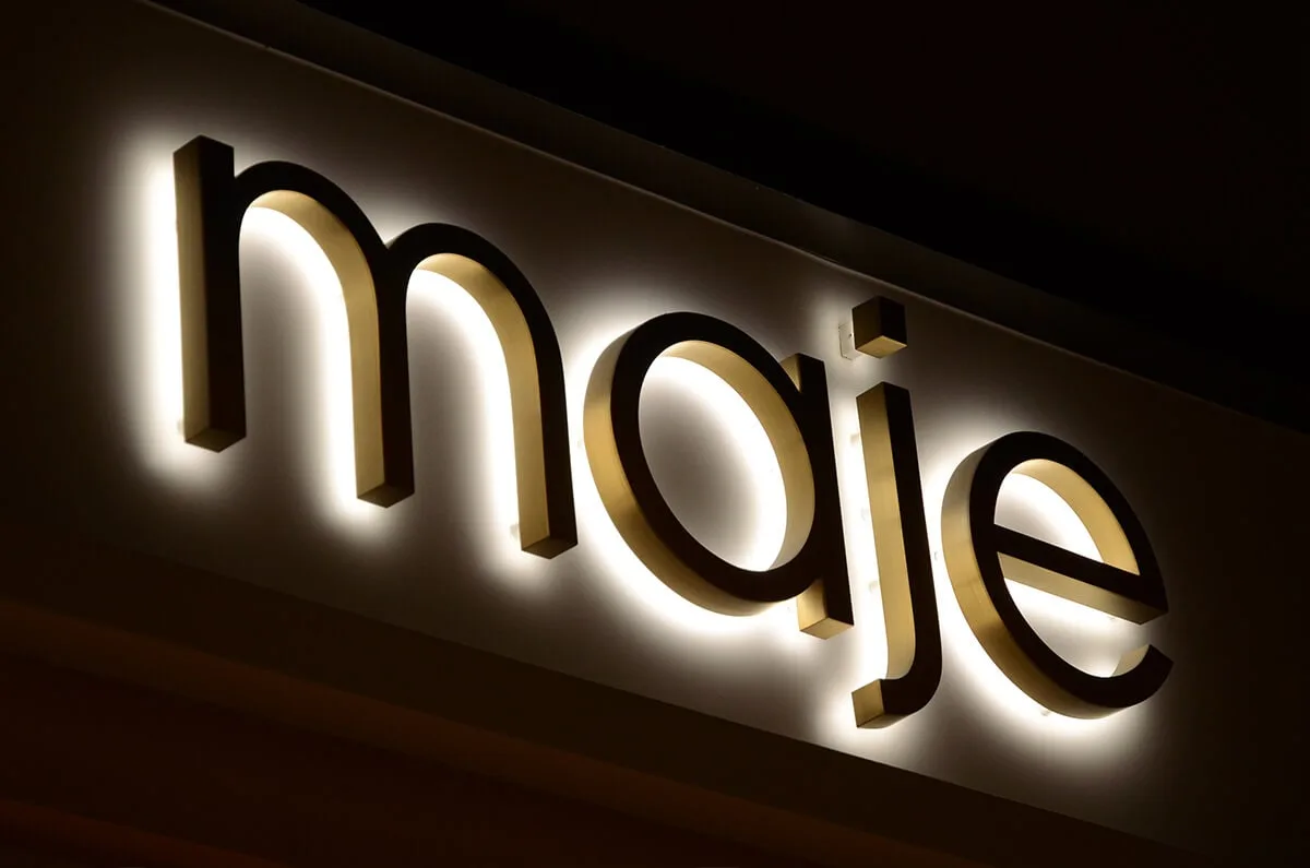 Classic backlit channel letters with a reflected halo on a large commercial facade