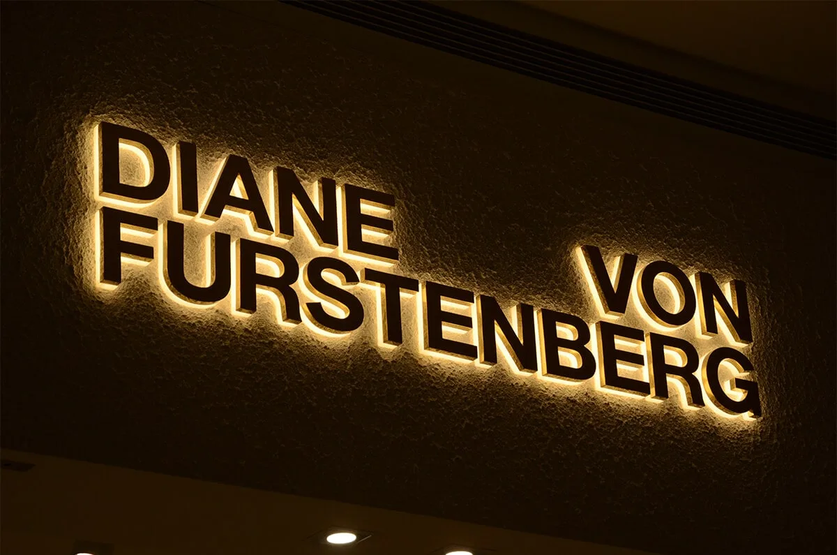 Luxury backlit channel letters mounted flush on a premium storefront