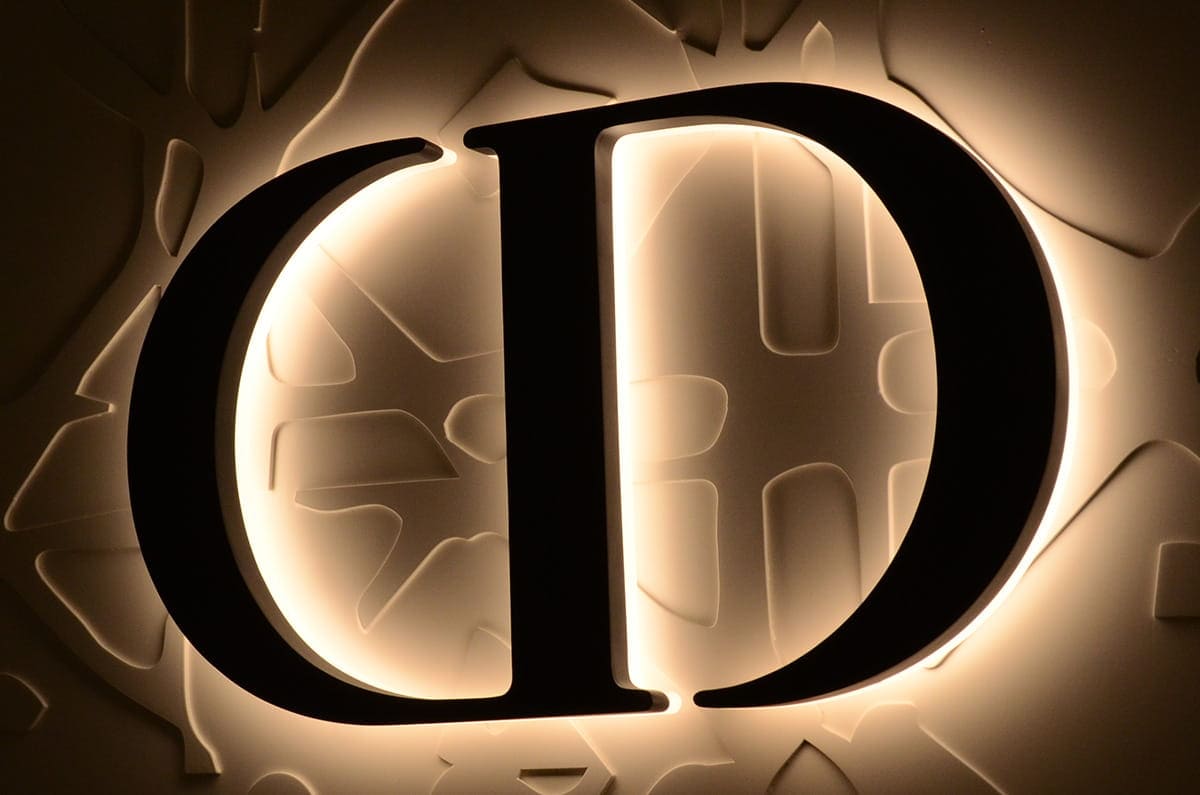 Custom large backlit letters on a building facade with a halo glow seen from a distance